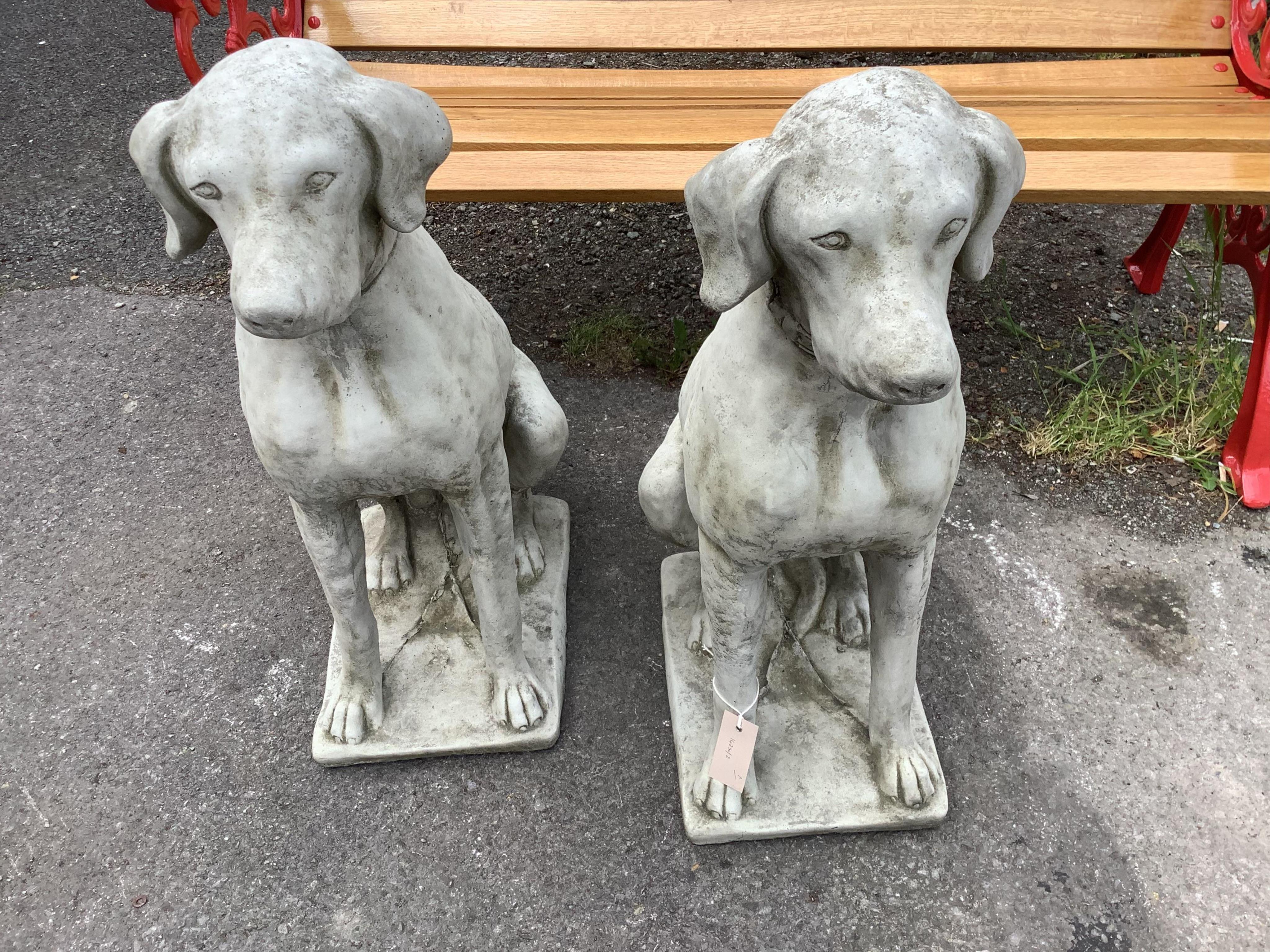 A pair of reconstituted stone seated hound garden ornaments, height 70cm. Condition - good